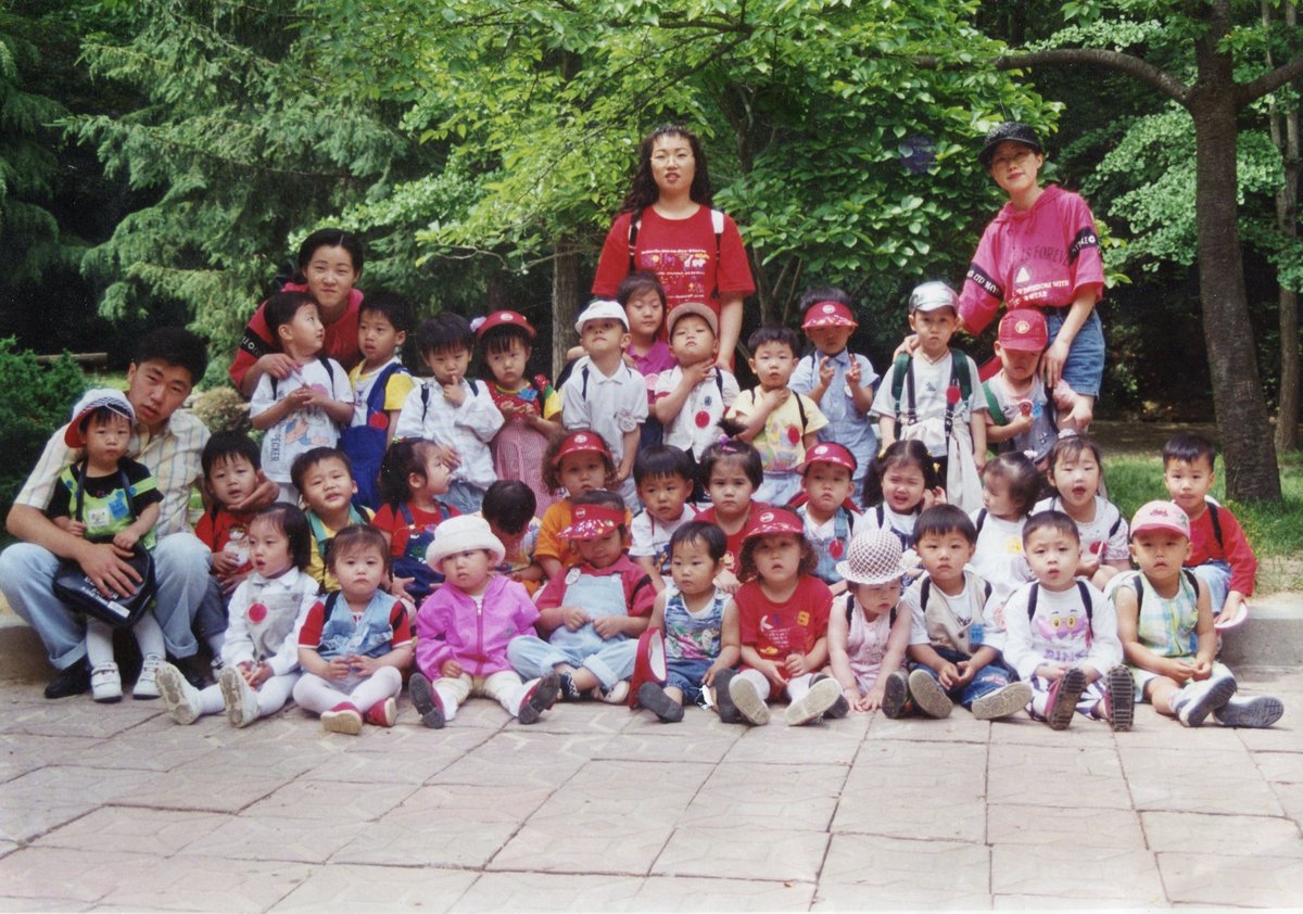 Gina Kim with daycare staff and children