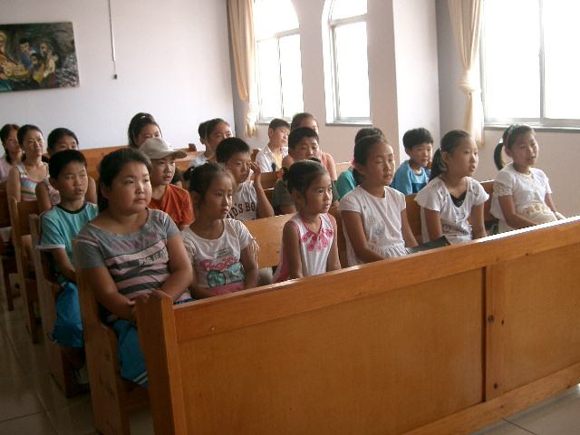 Children gathered in a chapel during a mission trip